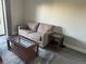 A living room with a comfortable couch, coffee table, side tables, and a rug at 13601 E Marina Dr # 510, Aurora, CO 80014