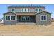 Two-story home with large windows, a covered patio, and a spacious backyard at 13765 Emerald Lake St, Parker, CO 80138