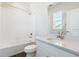 Bright bathroom features a tub-shower, modern vanity, and toilet at 13765 Emerald Lake St, Parker, CO 80138