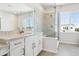 Modern bathroom features a glass-enclosed shower, dual sinks, and stylish tile work with great natural light at 13765 Emerald Lake St, Parker, CO 80138