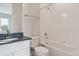 Clean bathroom with tiled shower over tub and black countertop vanity at 13765 Emerald Lake St, Parker, CO 80138