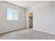 Neutral bedroom with a window for natural light and a convenient walk-in closet at 13765 Emerald Lake St, Parker, CO 80138