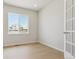 Bright bedroom featuring hardwood floors and a large window with a view of the neighborhood at 13765 Emerald Lake St, Parker, CO 80138