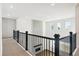 Hallway featuring wood floors, a view to the living room, and large windows for great natural light at 13765 Emerald Lake St, Parker, CO 80138