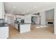 Open-concept kitchen flowing into the living area, featuring modern appliances and a cozy fireplace at 13765 Emerald Lake St, Parker, CO 80138