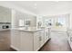 Open-concept kitchen with a large island, stainless steel appliances, and views of the living area at 13765 Emerald Lake St, Parker, CO 80138