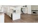 Well-lit open concept floor plan featuring wood floors, a kitchen, and fireplace with stone backsplash at 13765 Emerald Lake St, Parker, CO 80138