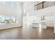 Open concept living area with large windows, wood floors, a kitchen and a second story view at 13765 Emerald Lake St, Parker, CO 80138