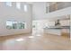 Open-concept living space with soaring ceilings, large windows, and a modern kitchen at 13765 Emerald Lake St, Parker, CO 80138