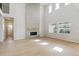 Spacious living room features a floor-to-ceiling fireplace, ample natural light, and hardwood floors at 13765 Emerald Lake St, Parker, CO 80138