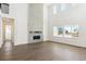 Bright living area featuring wood floors, a modern fireplace, and plenty of natural light from large windows at 13765 Emerald Lake St, Parker, CO 80138