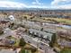 Aerial view of townhome community with tree lined river and mountain views at 5469 S Curtice St # E, Littleton, CO 80120