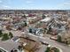 An aerial view of a neighborhood featuring homes and buildings of various styles and sizes with tree-lined streets at 5469 S Curtice St # E, Littleton, CO 80120