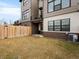 Private backyard features a well-maintained lawn, wooden fence, and patio area for outdoor enjoyment at 5469 S Curtice St # E, Littleton, CO 80120