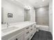 Modern bathroom with double sink vanity, sleek fixtures, and a tiled shower-tub combo at 5469 S Curtice St # E, Littleton, CO 80120