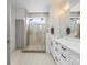 Modern bathroom with glass-enclosed shower, double vanity, and a bright, airy feel at 5469 S Curtice St # E, Littleton, CO 80120