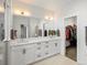 Bathroom with double vanity, large mirror and large closet at 5469 S Curtice St # E, Littleton, CO 80120