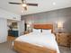 Bedroom with decorative trim, wooden bed frame, side tables, and lamps at 5469 S Curtice St # E, Littleton, CO 80120
