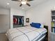 Well-lit bedroom showcasing an organized closet and a comfortable bed at 5469 S Curtice St # E, Littleton, CO 80120