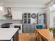 A modern kitchen with stainless steel appliances, custom cabinets, a large center island, and an adjacent dining area at 5469 S Curtice St # E, Littleton, CO 80120