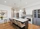 Bright, modern kitchen with a center island, stainless steel appliances, and hardwood flooring at 5469 S Curtice St # E, Littleton, CO 80120