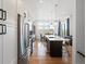 Modern kitchen with stainless steel appliances, white cabinets, a large center island, and hardwood flooring at 5469 S Curtice St # E, Littleton, CO 80120