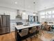Modern kitchen with stainless steel appliances, white cabinets, and center island with barstool seating at 5469 S Curtice St # E, Littleton, CO 80120