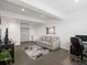 Cozy living room with neutral tones, stylish mirror, and ample space for relaxation and entertainment at 5469 S Curtice St # E, Littleton, CO 80120