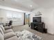 Bright living room with gray sofa, desk, and large sliding glass door to the outside at 5469 S Curtice St # E, Littleton, CO 80120