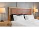 Close up of bed in main bedroom with lamps at 5469 S Curtice St # E, Littleton, CO 80120