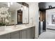 Bathroom showcasing a double vanity with modern fixtures, leading to the walk-in closet and bedroom at 1750 Wewatta St # 1304, Denver, CO 80202