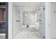 Luxurious bathroom featuring a marble-tiled shower with a built-in bench and glass door at 1750 Wewatta St # 1304, Denver, CO 80202