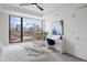 Bright bedroom featuring a large window with stunning city views and a modern white desk at 1750 Wewatta St # 1304, Denver, CO 80202