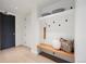 Hallway with a custom storage nook featuring a built-in bench, coat hooks and shelves for storing personal items at 1750 Wewatta St # 1304, Denver, CO 80202