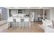 Contemporary kitchen with gray cabinetry, stainless steel appliances, white countertop island, and counter seating at 1750 Wewatta St # 1304, Denver, CO 80202