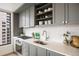Modern kitchen features gray cabinets, stainless steel appliances, and a bright window at 1750 Wewatta St # 1304, Denver, CO 80202