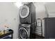 Convenient laundry room featuring a modern stacked washer and dryer set at 1750 Wewatta St # 1304, Denver, CO 80202