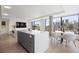 Open living space features a kitchen island, dining area, and expansive city views at 1750 Wewatta St # 1304, Denver, CO 80202