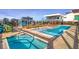 Relaxing rooftop pool area with in-pool lounge chairs and hot tubs with beautiful blue tile at 1750 Wewatta St # 1304, Denver, CO 80202