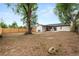 Large backyard with a patio, shade trees, and a new fence offering ample space for activities at 3061 S Glencoe St, Denver, CO 80222