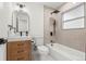 Modern bathroom features tile accents, black hardware, and a wood vanity at 3061 S Glencoe St, Denver, CO 80222