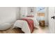 Charming bedroom featuring a cozy bed with a decorative throw and natural light at 3061 S Glencoe St, Denver, CO 80222