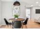 Stylish dining area showcasing a round table with modern chairs and unique wall art at 3061 S Glencoe St, Denver, CO 80222
