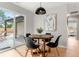 Cozy dining area with a modern table, stylish chairs, and access to the outdoor patio at 3061 S Glencoe St, Denver, CO 80222