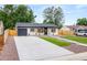 Inviting single story home featuring manicured lawn, concrete driveway, and attached garage at 3061 S Glencoe St, Denver, CO 80222