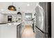 Modern kitchen featuring stainless steel appliances, a stylish island, and pendant lighting at 3061 S Glencoe St, Denver, CO 80222