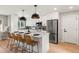Bright kitchen with stainless steel appliances, gray backsplash, and a large island with seating at 3061 S Glencoe St, Denver, CO 80222