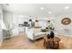 Bright, open-concept living room with modern decor, island with pendant lighting and stainless appliances at 3061 S Glencoe St, Denver, CO 80222