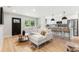 Airy living room with hardwood floors, comfortable seating, and a view of the contemporary kitchen at 3061 S Glencoe St, Denver, CO 80222