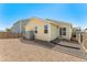 This backyard is gravel-covered and features a storage container and a sliding glass door at 47385 Lily Ave, Bennett, CO 80102